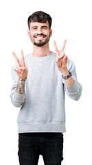 Sticker - Young handsome man wearing sweatshirt over isolated background smiling looking to the camera showing fingers doing victory sign. Number two.