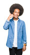 © Krakenimages.com - Young african american man with afro hair smiling doing phone gesture with hand and fingers like talking on the telephone. Communicating concepts.