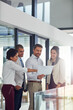 © peopleimages.com - Talking, business people and document for review, collaboration and advice as feedback in office. Group, paperwork and discussion as teamwork, development and mentorship in brainstorming for company