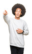 © Krakenimages.com - Young african american man with afro hair wearing sporty sweatshirt Pointing with finger surprised ahead, open mouth amazed expression, something in front