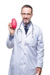 © Krakenimages.com - Middle age senior hoary cardiologist doctor man holding heart over isolated background with a confident expression on smart face thinking serious