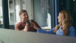 © stockbusters - Cheerful coworkers enjoy coffee in office workspace closeup. Happy man woman