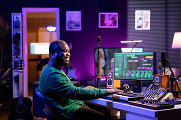 Aufkleber - Male artist producing music on electronic piano keyboard in home studio. Sound engineer playing MIDI controller, recording and composing a soundtrack with acoustic tools and gear.