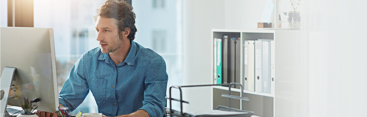 Leinwandbilder - Computer, typing and web development with business man at desk in office for planning or research. Banner, mockup and space with confident employee in workplace for online review of information
