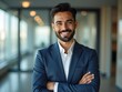 © Niphon - Confident smiling indian business man male financial analyst employee professional worker stand in office with crossed arms arabian handsome adult investor posing look at camera happy face expression