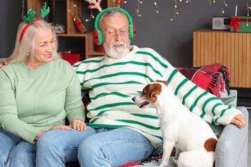 Canvas Print - Happy mature couple with dog at home on Christmas eve