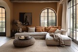 A beautifully designed living room features a mocca mousse color palette, with earthy tones and plush seating. Natural light floods through the large windows, enhancing the warm ambiance