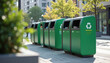 © miss irine - Urban eco friendly recycling bins. Modern green waste containers line city street. Sustainable urban eco design. Clean environment. People walk by. City center. Sunny day.