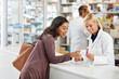 © peopleimages.com - Drugstore, woman and consulting pharmacist with box for pills side effects, prescription drugs dosage and advice. Friendly, expert or customer service in pharmacy with medication treatment by counter