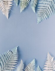 Wall Mural - Pastel blue fern leaves arranged on a light blue background.