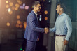 © peopleimages.com - Deal, handshake and welcome with business men in office for meeting, partnership or thank you. Bokeh, team and smile with employee people shaking hands for onboarding or recruitment on space