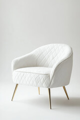 White quilted fabric armchair in classical Art Deco style with brass legs, isolated on white