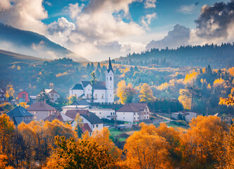 Wall Mural - Long phocus picture of Catholic church of St. Michael the Archangel. Autumn scene of Valaska Dubova, village and municipality in Ruzomberok District in the Zilina Region of northern Slovakia.