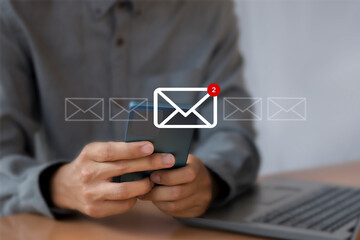 Wall Mural - man uses laptop with notification icon of two new email messages. communication business technology.