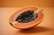 © ThomasLENNE - Cloe view of a papaya fruit on orange blurred background. Colorful Studio shot, harsh light.
