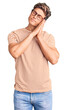 © Krakenimages.com - Young handsome man wearing casual clothes and glasses sleeping tired dreaming and posing with hands together while smiling with closed eyes.