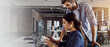 © peopleimages.com - Creative, design on laptop and employee with mentor in office for web development training. Assistance, banner or introduction with business man and woman in workplace for system integration