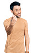 © Krakenimages.com - Hispanic man with beard wearing casual t shirt beckoning come here gesture with hand inviting welcoming happy and smiling