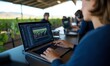 © Tondone - Person working on video editing software on a laptop in an outdoor setting, surrounded by nature