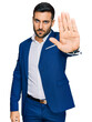 © Krakenimages.com - Young hispanic man wearing business jacket doing stop sing with palm of the hand. warning expression with negative and serious gesture on the face.