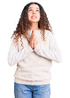 © Krakenimages.com - Beautiful kid girl with curly hair wearing casual clothes begging and praying with hands together with hope expression on face very emotional and worried. begging.