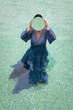 © Milou Dirks - art portrait of woman in blue dress standing in water of swimming pool holding round mirror hiding her face