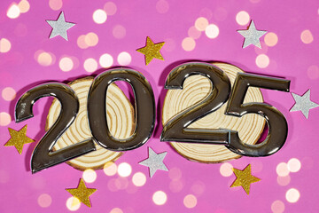 Wall Mural - golden numbers 2025 two thousand twenty five new year with colorful stars confetti on wooden trunk, bokeh light