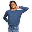 © Krakenimages.com - Young african american man wearing casual winter sweater suffering of neck ache injury, touching neck with hand, muscular pain
