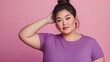 © bird_saranyoo - Plus-sized East Asian woman in a purple t-shirt, posing with confidence in a studio