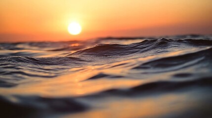 Poster - Warm orange and pink hues fill the sky as the sun sets over the horizon. Gentle waves reflect the light, creating a peaceful atmosphere