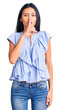 © Krakenimages.com - Young beautiful latin girl wearing casual clothes asking to be quiet with finger on lips. silence and secret concept.