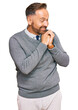 © Krakenimages.com - Handsome middle age man wearing business clothes laughing nervous and excited with hands on chin looking to the side