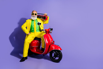 Wall Mural - Photo of cheerful positive man pensioner wearing yellow trendy costume listening music isolated on purple color background