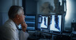 © Gorodenkoff - Experienced Radiographer Examines Chest X-rays on Multiple Computer Monitors in a Dark Medical Room. Modern Diagnostic Equipment Ready to Take Medical Imaging Scans of a Male Patient