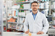 © peopleimages.com - Confidence, portrait and mature man in pharmacy with pills, pharmaceutical drugs and prescription medicine. Healthcare, medical service and pharmacist in dispensary with professional advice in store