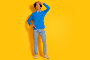 Wall Mural - Full size photo of pretty young male look forward touch forehead wear trendy blue outfit isolated on yellow color background