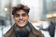 © plysuikvv - Smiling young man in winter coat on city street in daytime