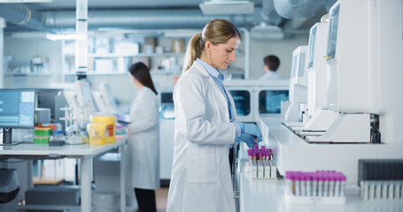 Aufkleber - Team of Biomedical Engineers Work in a Lab. Senior Researcher Adding Samples to Test Machine, Asian Female Adjusting Settings on a Digital Microscope while Male Colleague Carrying Medical Glassware