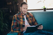 © deagreez - Attractive young man with brown hair writing in notebook while relaxing on sofa in stylish apartment