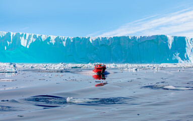 Wall Mural - fast moving motorboat trying to get out of the ice - stranded icebergs in the fog at the mouth of th