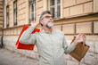 © Miljan Živković - Portrait of smile senior man with shopping bags on the street