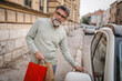 © Miljan Živković - senior man hold shopping bags and unlock the car ready to go home