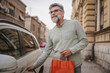 © Miljan Živković - senior man hold shopping bags and unlock the car ready to go home