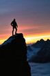 © SnowElf - Silhouette of a man standing on the edge of a mountain cliff on the background of sunset nature and the sky, creatine concept of achieving a goal, success
