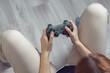 © daniiD - Joystick in hand: a person spends time playing games, a focused look, a relaxed