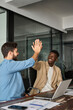 © insta_photos - Happy diverse young business men colleagues work team partners giving high five as concept of friendly help, corporate goal achievement, project market growth, trust and support in teamwork. Vertical