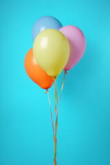 a colorful balloon is seen on a blue colored background that evokes images of parties and celebratio