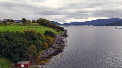 Wall Mural - Drone over a fall-colored shore near Flatsetoeya Island countryside in Kristiansund, Norway