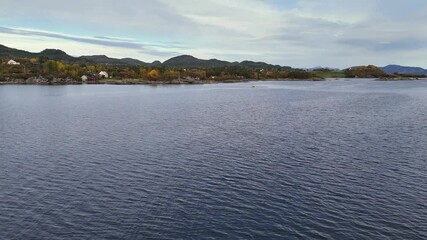 Wall Mural - Drone over a fall-colored shore near Flatsetoeya Island countryside in Kristiansund, Norway