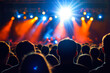 © romanets_v - Vibrant concert crowd enjoying live music performance with dynamic stage lighting